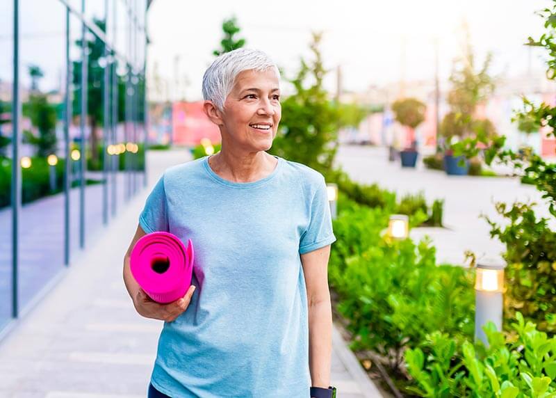 Woman Holding a Yoga Mat