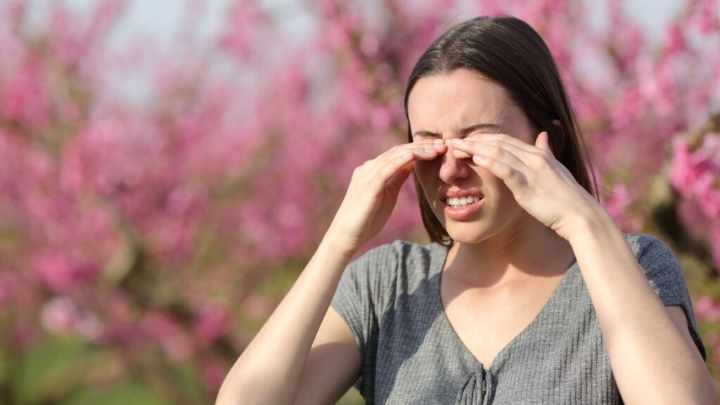 woman rubbing her eyes